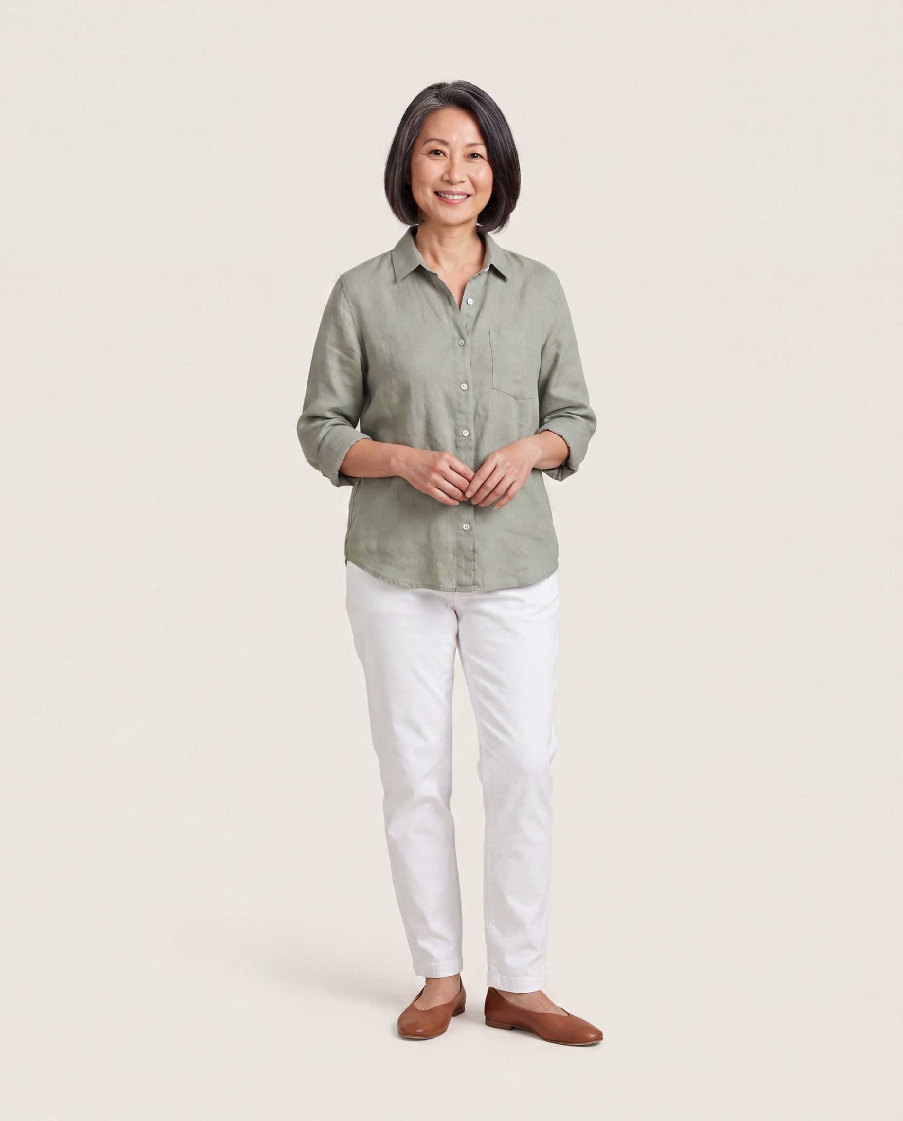Woman in her fifties in a sage linen shirt