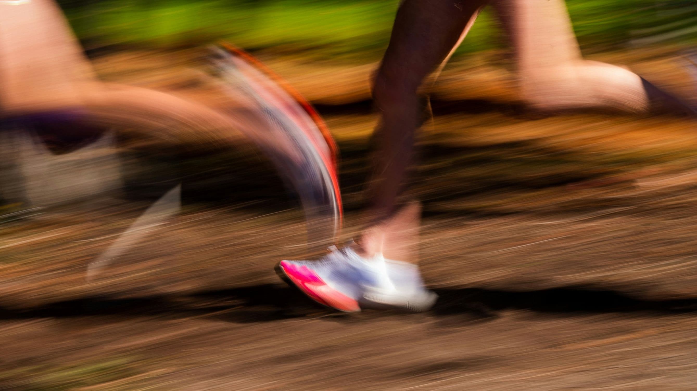 A photo of runners legs and feet on a track
